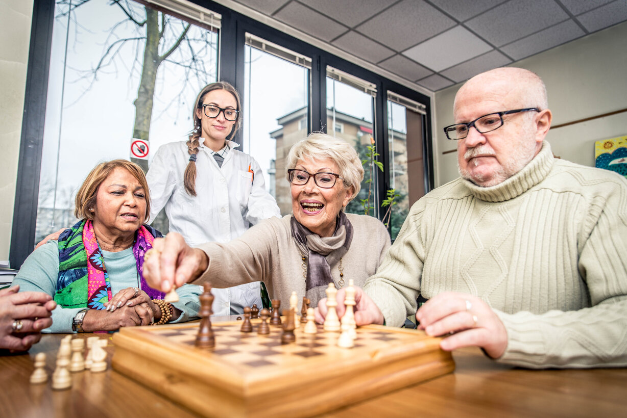 Seniors playing chess in dementia care in Fresno, CA.